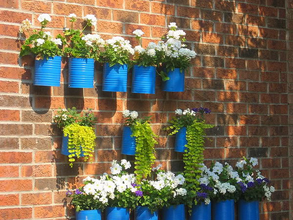 Blue painted tin can as wall container garden. Tin cans are not just for stacking up in your cabinet, tossing in the trash or sending to the recycle bin. Combine those with a rope, paints, craft papers and a generous helping of crazy imagination, and you will have a cool creation on your hands. 