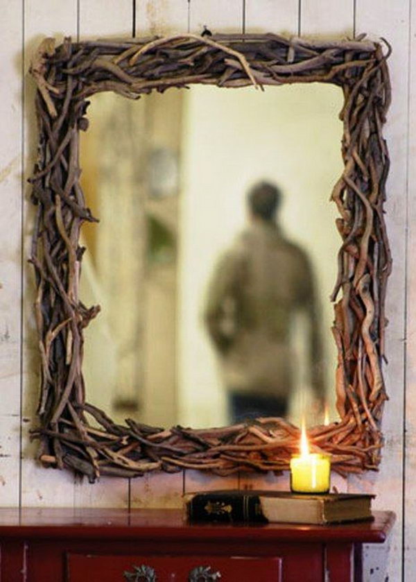 What an effective and stylish mirror frame made from twigs. 