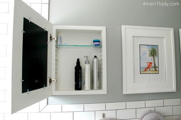 Hide bathroom cabnets behind wall art. They provide more than enough hidden storage. 