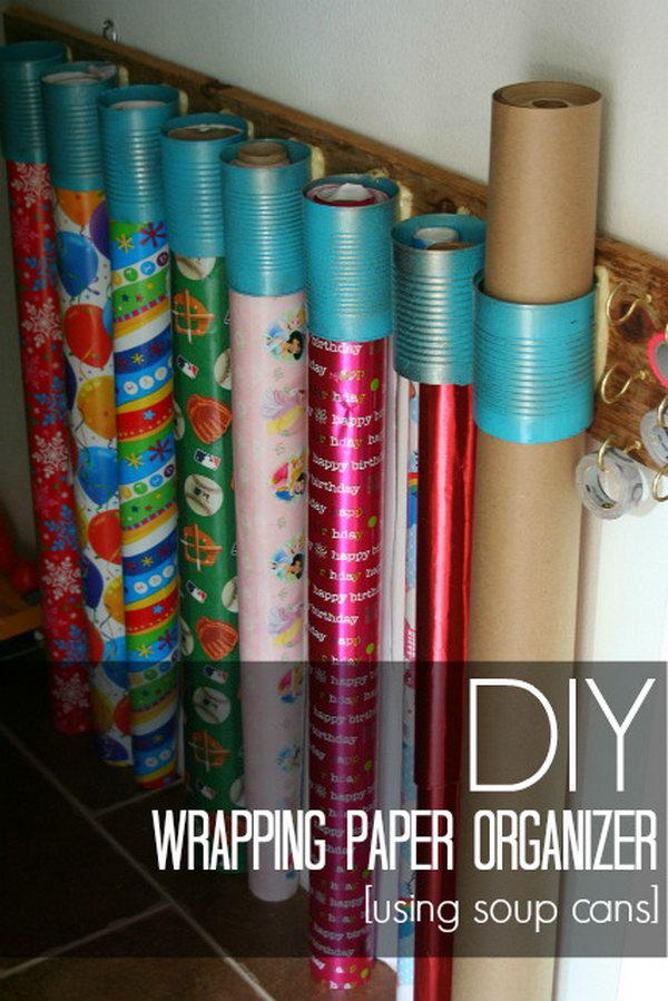 DIY wrapping paper organizer made from soup cans and scrap wood. 