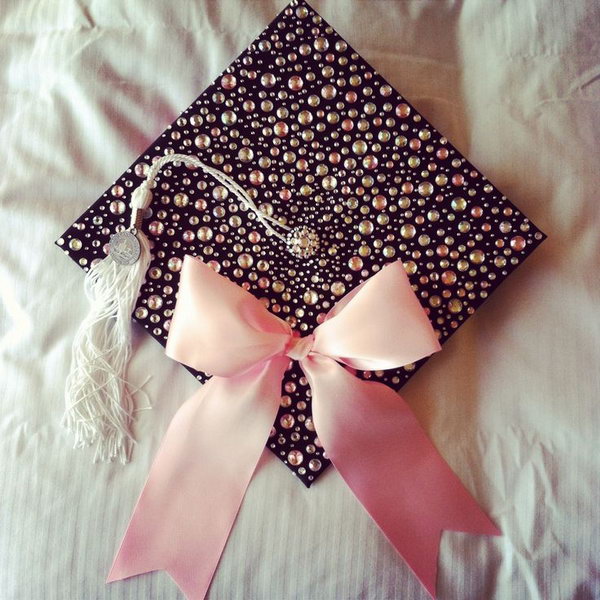 Pink Bow Graduation Cap. Congratulation to the graduate success with this elegant graduation cap with all its sparkling beadings as well as smooth pink ribbon bow to add up more beauty to this art piece. 