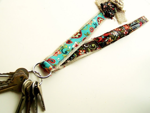 Badge Holder. Sew the beautiful patterned strips, secure flower and add a pocket to place your pens for beautiful decorative badge holder. It's easy to make and you can create this with little expenditure. 