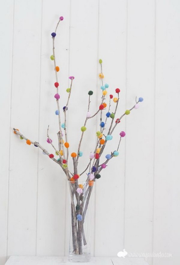 Pom pom Branch Bouquet. Use the glue gun to secure colorful pom poms on the branch in a beautiful display. Insert in a flower vase for beautiful decor with low cost. 