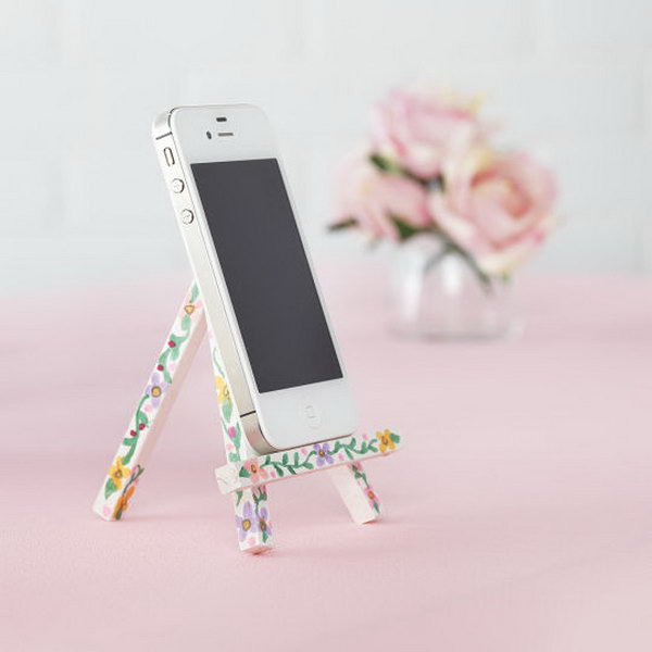 iPhone Easel. Paint the easel with acrylic paint and use sharpie markers to draw floral pattern on it for beautiful garnishment. 