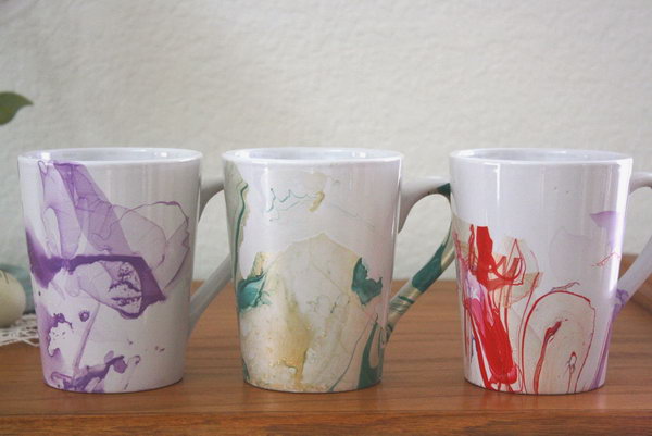 DIY Watercolor Coffee Mug. If you're tired of that plain coffee mug, change the look by painting it with nail polish and water. Here is the tutorials for you . 