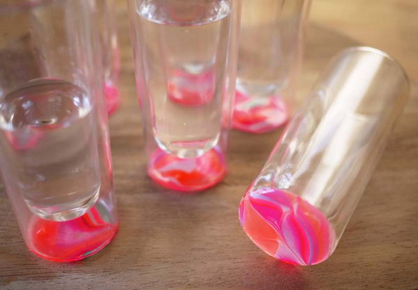 DIY Marbled Glassware. It's a super great way to refresh your boring and plain glasses  to a fashionable addition to your next table centerpieces during a party with the bright and bold colors of the nail polish. 