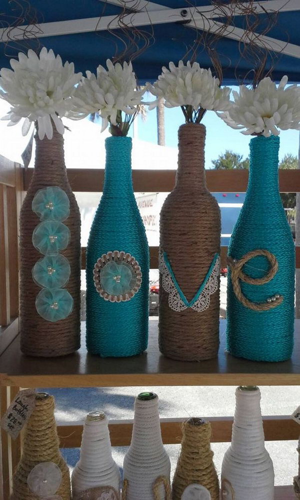 Upcycled Rope wrapped Wine Bottles as a wedding Decor. These adorable rope wrapped wine bottles with the letters to spell LOVE are wonderful for a wedding with flowers in. 