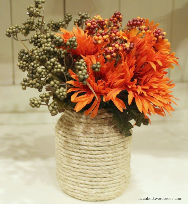 DIY Rope Wrapped Vase. A vase, some ropes, hot glue gun and hot glue are all you need to make this rope wrapped vase. It will be an amazing table centerpiece with some fall flowers and leaves in. 