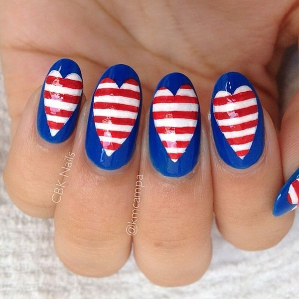 4th of July Love Nail Art: This design is a funky take on flag inspired nails. Start with a navy blue base and heart middle. Then freehand paint the white and red stripes using a nail art brush. I love the American heart so much. 