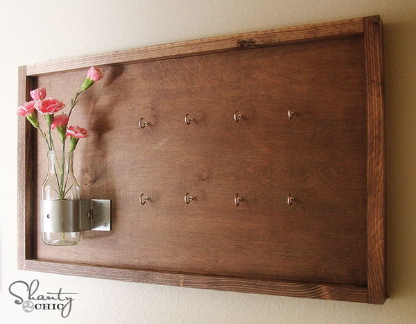 DIY Key Holder Decorated with Vase and Flowers.  This version of a key holder features an old board but decorated with vases and flowers. It looks good on the wall, replacing beautifully any painting or artwork, but holding your keys as well. See more 