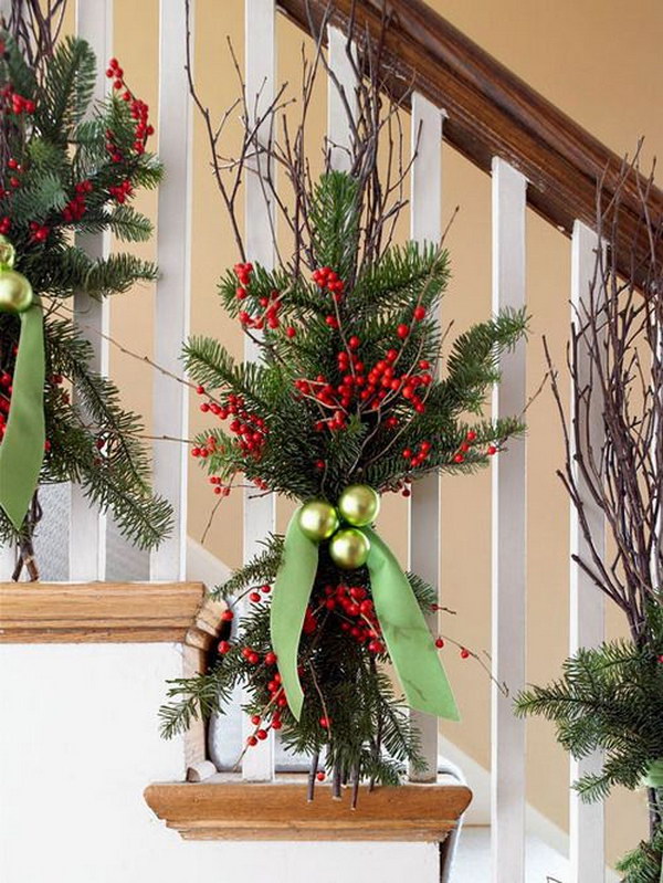 tie up some tree branches and berry branches with an elegant light green ribbon for stairs 