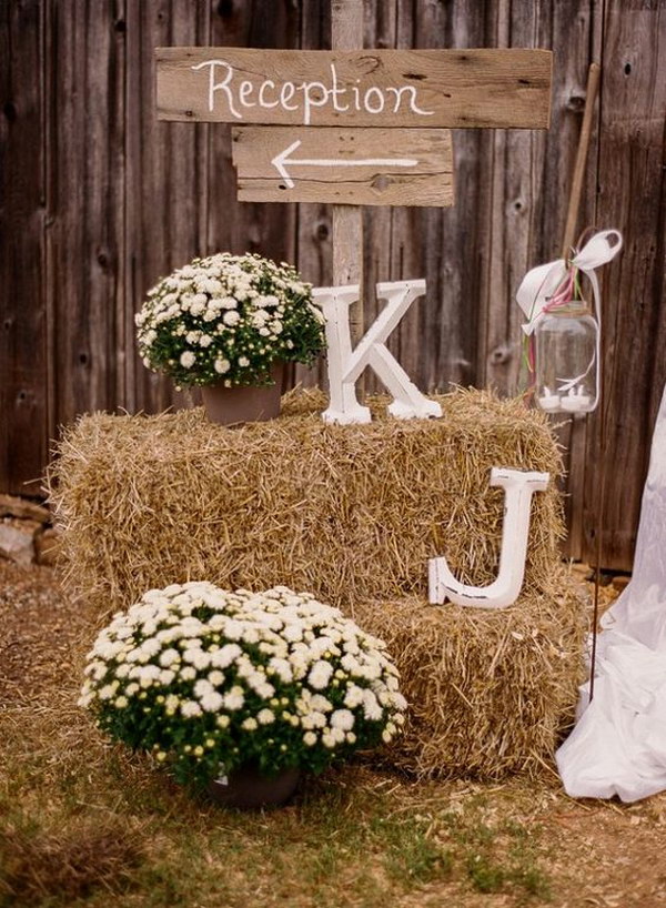 Distressed Monogram Paired with Simple Flowers and Displayed on Hay Bales 