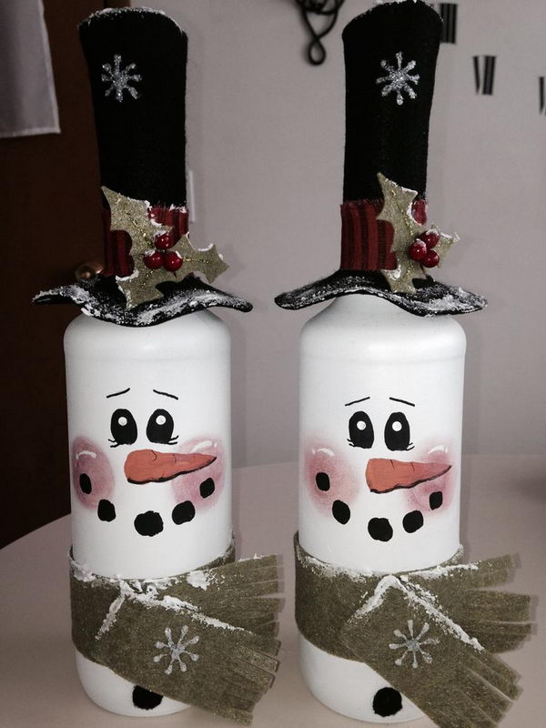 DIY Wine Bottle Lights. Take two empty wine bottles. Spray paint them white. Then draw the faces with paint and dress them up with felt accessories! (Hat comes off to add lights inside bottle.) 