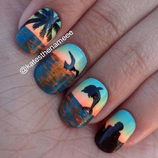 Beach inspired nail art with classic coconut trees and dolphin silhouettes, but a silhouette of a tourist as well. 