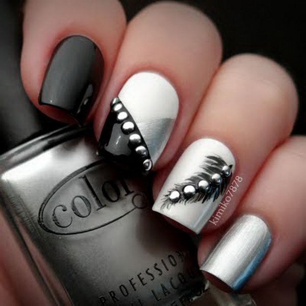 Rocker Chic Feather Nails with Silver Studs. Very pretty! I have to say, I am really into this feather design. 