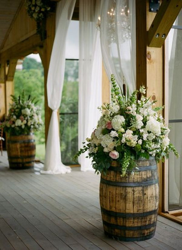 Wine Barrels Decorated With Colorful Flower Bouquets. 