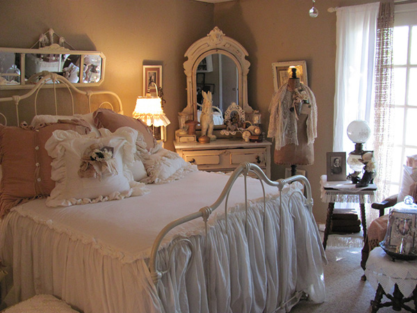 The Chic Kind Of Shabby with the Raised Arch of the Wrought Iron Bed. 